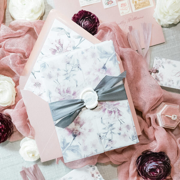 grey and mauve wedding invitation with wax seal and silk ribbon