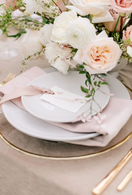 table setting with roses and a handmade paper place card